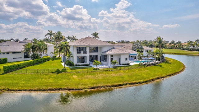 rear view of property with a water view, a fenced front yard, a fenced in pool, and a yard