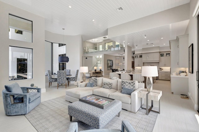 living room with wood ceiling, visible vents, and recessed lighting