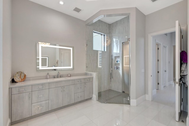 full bath with a stall shower, baseboards, visible vents, and vanity