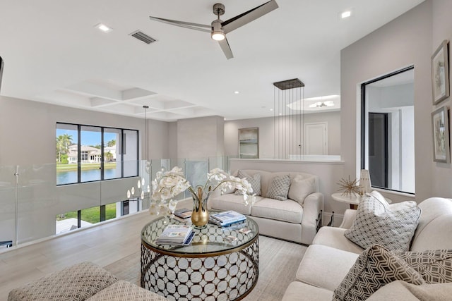 living room featuring visible vents, coffered ceiling, ceiling fan, wood finished floors, and recessed lighting