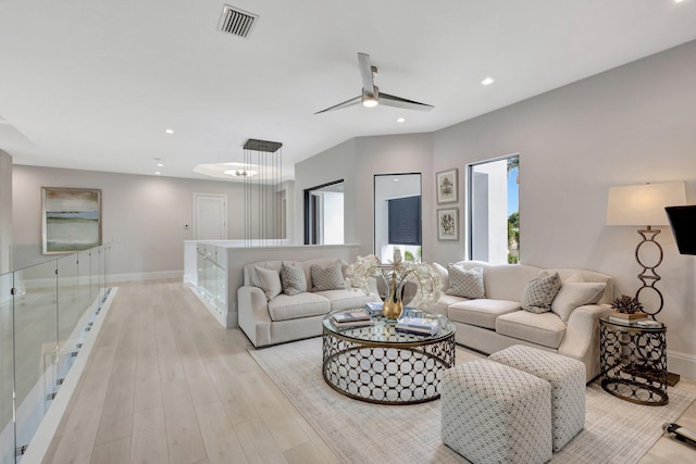 living room with baseboards, visible vents, ceiling fan, light wood-style floors, and recessed lighting