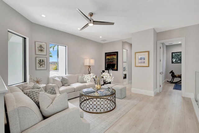 living area with light wood-style flooring, baseboards, ceiling fan, and recessed lighting