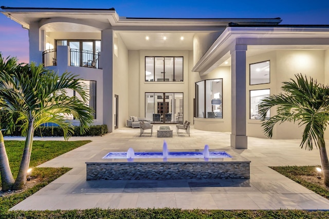 back of property with a patio area and stucco siding