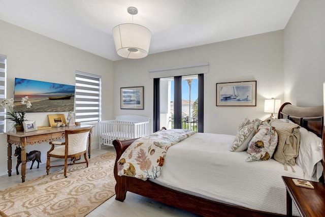 bedroom with access to outside, multiple windows, and french doors