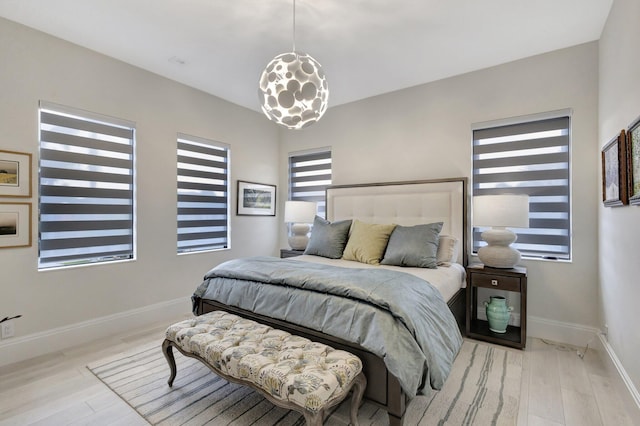 bedroom with baseboards and wood finished floors