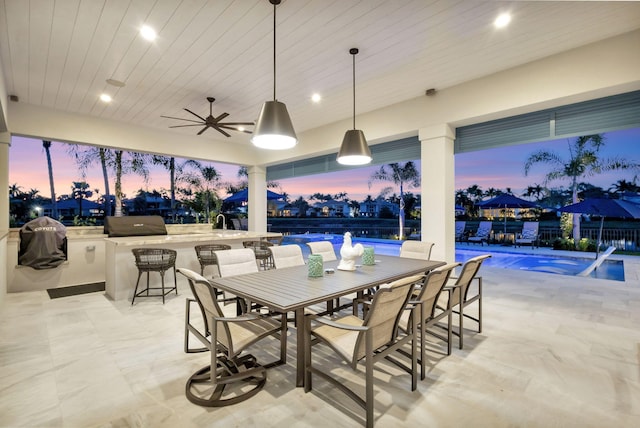 patio terrace at dusk with a fenced in pool, area for grilling, ceiling fan, fence, and outdoor dining area