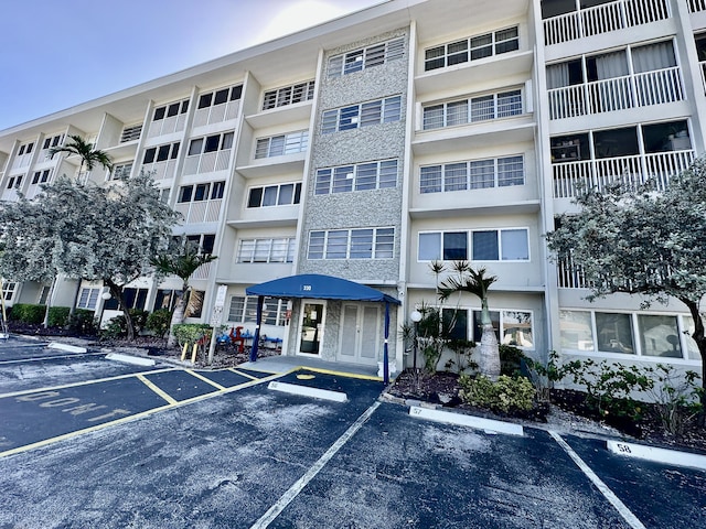 view of property featuring uncovered parking