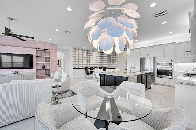 dining space featuring marble finish floor, ceiling fan with notable chandelier, visible vents, and recessed lighting