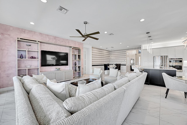 living room with ceiling fan, marble finish floor, visible vents, and recessed lighting