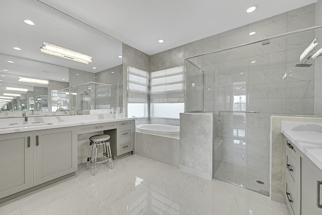 full bath featuring marble finish floor, vanity, a shower stall, a bath, and recessed lighting