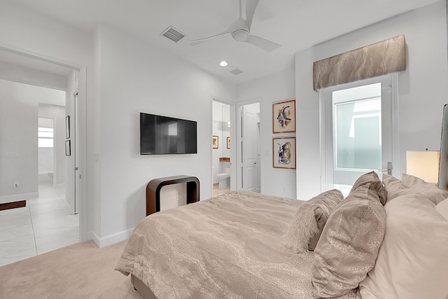 bedroom with ensuite bathroom, light colored carpet, a ceiling fan, baseboards, and visible vents