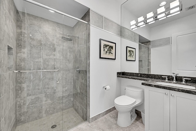 bathroom with visible vents, baseboards, toilet, vanity, and a shower stall