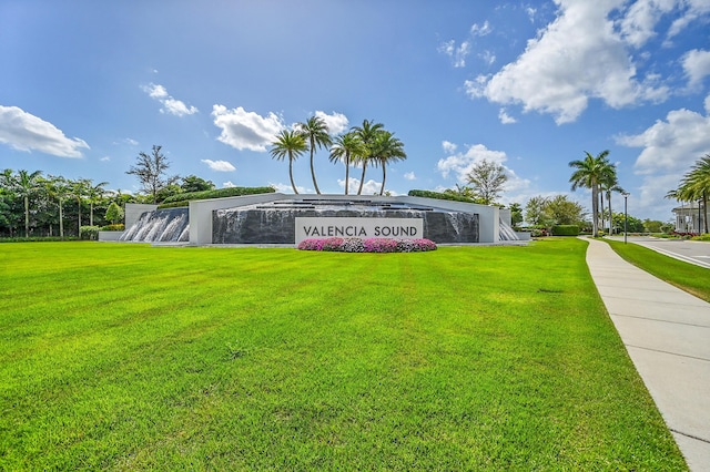 community sign featuring a lawn