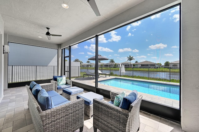 view of swimming pool featuring ceiling fan, a patio area, fence, and an outdoor hangout area