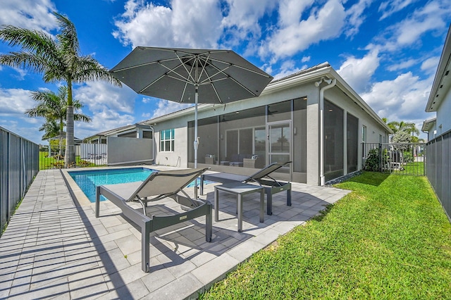 back of property featuring a sunroom, a fenced backyard, a patio, and a yard