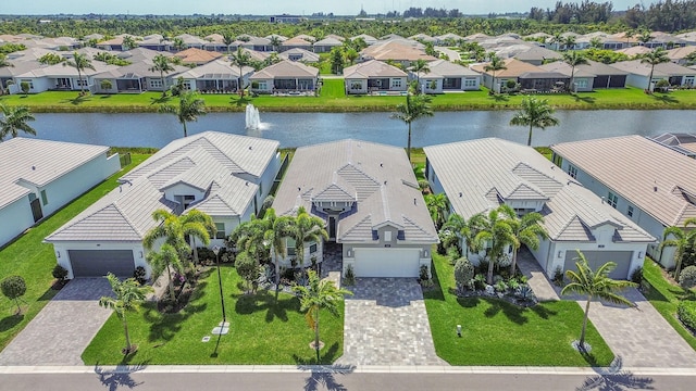 birds eye view of property featuring a water view and a residential view