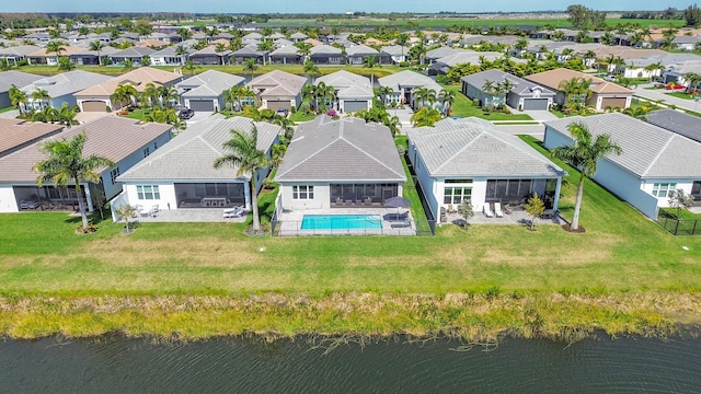 birds eye view of property featuring a residential view and a water view