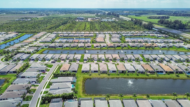 bird's eye view featuring a water view and a residential view