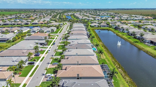 birds eye view of property featuring a water view and a residential view