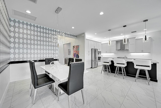 dining room featuring baseboards, visible vents, an accent wall, marble finish floor, and recessed lighting