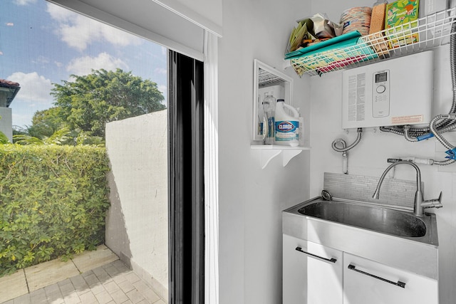 interior space featuring tankless water heater and a sink