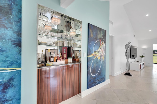 bar featuring high vaulted ceiling, tile patterned flooring, recessed lighting, baseboards, and a dry bar