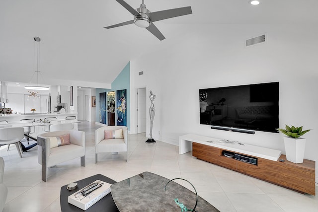 living area featuring light tile patterned floors, visible vents, a ceiling fan, high vaulted ceiling, and baseboards