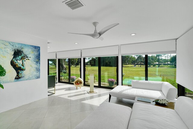 tiled living area with plenty of natural light, recessed lighting, visible vents, and ceiling fan