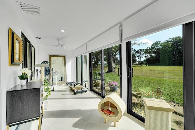 sunroom with ceiling fan and visible vents