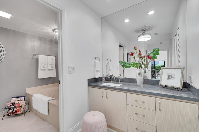 full bathroom featuring recessed lighting, a bath, and vanity