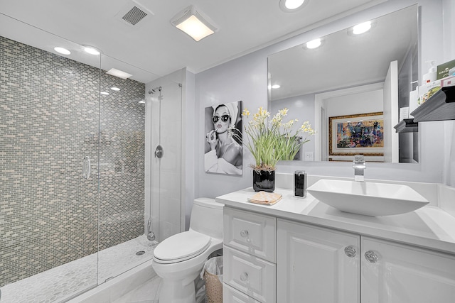 bathroom with toilet, a shower stall, visible vents, and vanity