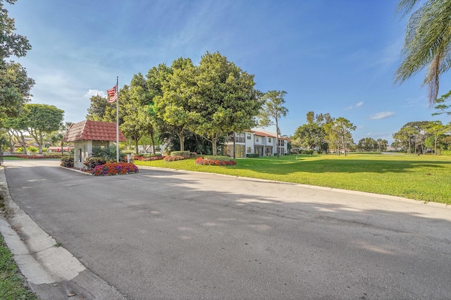 view of street featuring curbs and a gated entry