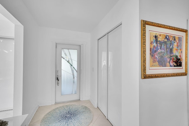 doorway with light tile patterned floors