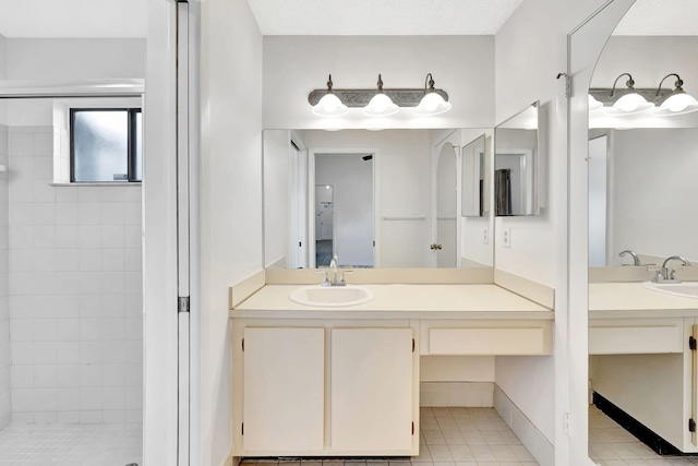 full bath with a stall shower, tile patterned flooring, and vanity