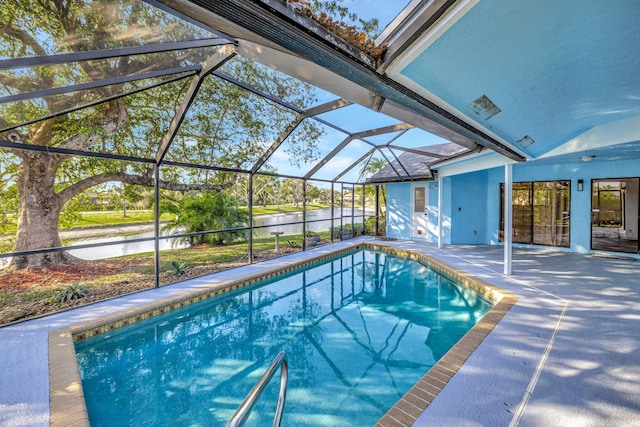 pool with a water view, a lanai, and a patio