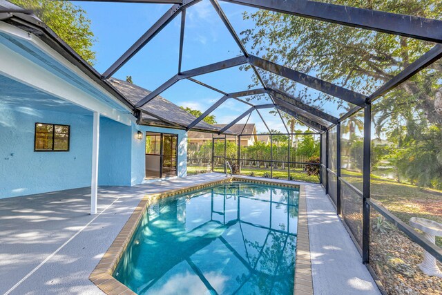 pool with a patio and a lanai