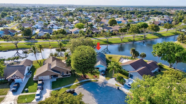 drone / aerial view with a water view and a residential view