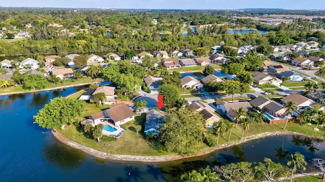 birds eye view of property with a residential view and a water view