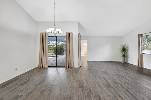 interior space featuring lofted ceiling, a notable chandelier, baseboards, and wood finished floors