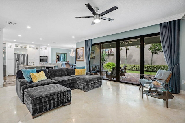 living area featuring light tile patterned floors, visible vents, a ceiling fan, crown molding, and recessed lighting