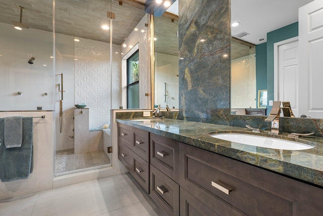 full bath featuring a stall shower, visible vents, a sink, and tile patterned floors