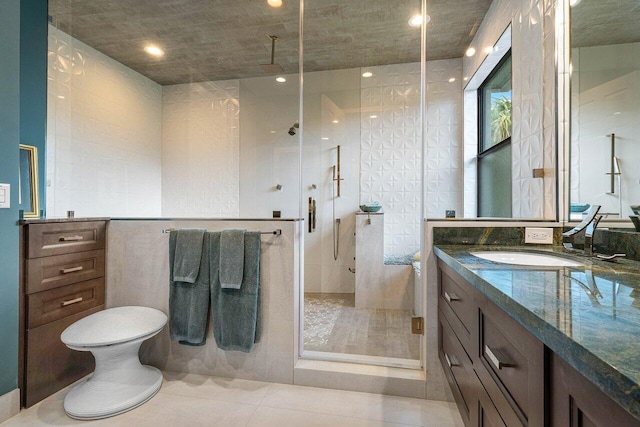 full bath featuring a stall shower, tile patterned flooring, and vanity