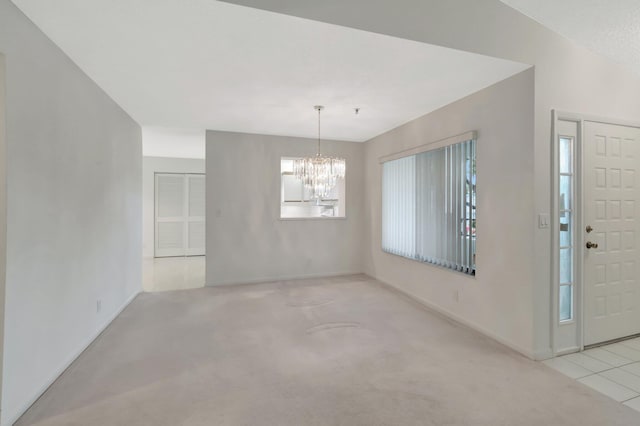 carpeted entryway with a notable chandelier and baseboards