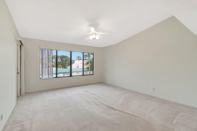 empty room with light colored carpet, baseboards, and ceiling fan