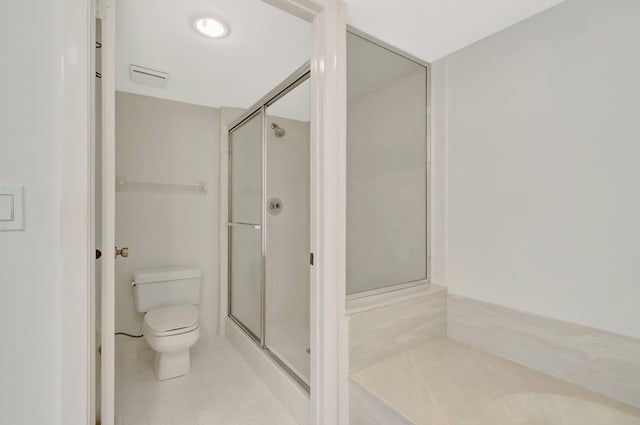 full bathroom with tile patterned floors, toilet, and a stall shower