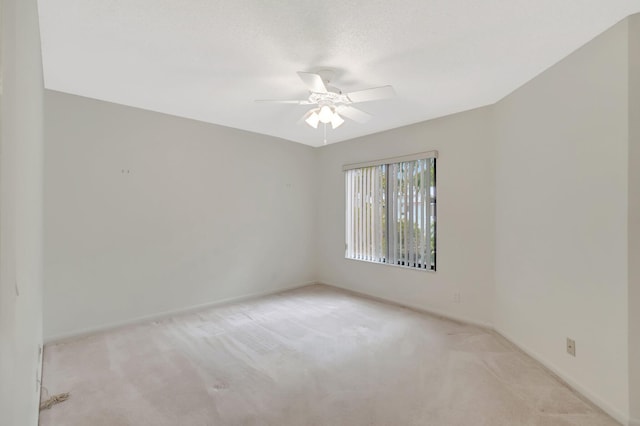 unfurnished room featuring a ceiling fan, carpet, baseboards, and a textured ceiling