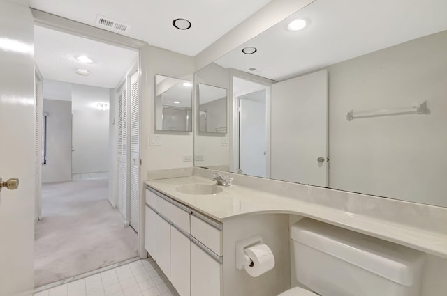 bathroom with recessed lighting, visible vents, toilet, and vanity