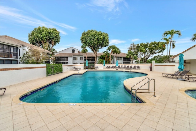 pool featuring a patio and fence