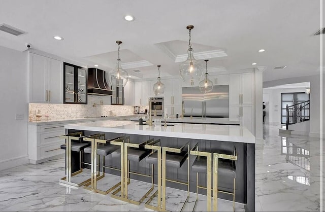 kitchen with marble finish floor, light countertops, custom range hood, visible vents, and appliances with stainless steel finishes