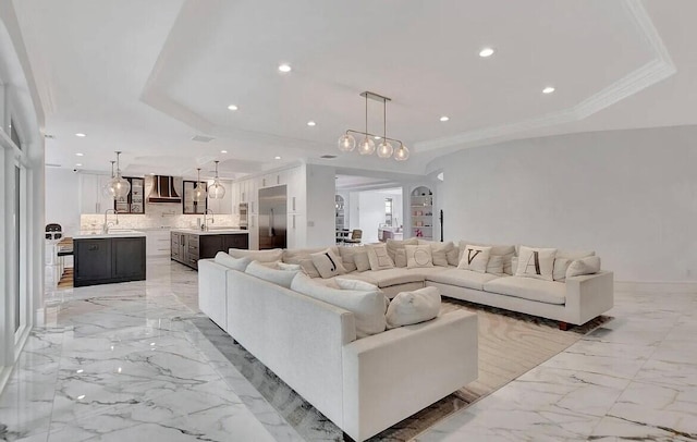 living room featuring crown molding, marble finish floor, a raised ceiling, and recessed lighting